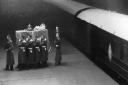 King George VI's coffin being taken from the ten-coach funeral train. Large crowds had gathered in Ely to pay their respects.