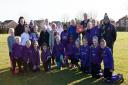 Huntingdon Girls Football Club stand proudly with their new defibrillator.