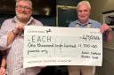 Soham shop manager Darren Martin (left) receiving a cheque for £1,700 from Soham and Staploe Rotary Club president Stuart Cavanagh.