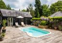 A decking surrounds the pool