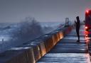 Rough seas batter Walcott as dawn breaks on the Norfolk coast as spring tides and winter weather combine to cause flood warnings. Simon Finlay Photography.