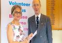 Mercedes receiving certificate of Long Service Award and gold logo pin badge from Deputy Lieutenant, His Honour Neil McKittrick