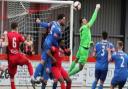 Stamford goalkeeper Danny Haystead punches clear to thwart a Wisbech attack.