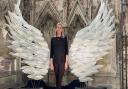 Glass-blower Layne Rowe's stunning angel wings sculpture at Ely Cathedral's Lady Chapel. Jocelyn Palmer, events manger at Ely Cathedral, in front of the installation.