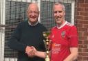 Wisbech Town walking football team captain Richard Mellor with the trophy.