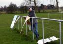 Edwin Fey, chairman of March Bears RUFC, with sponsorship boards that have been vandalised at the ground.