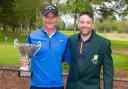 Club captain Andy Hicks presents overall winner Neil Cousins with his trophy