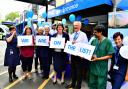 Staff at the Queen Elizabeth Hospital celebrate the news it will be replaced