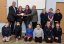 Guide leaders Marcia Whitehead and Natalie Taylor receiving a cheque from Wisbech Freemasons David Broker and Richard Smith, pictured with some of the guides.