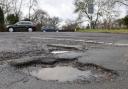 Stock image of a pothole.