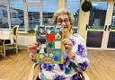 Resident, Betty, showcasing her Elvis scrapbook masterpiece she created in craft club, in honour of the King of rock and roll on his birthday.