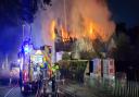 Firefighters battle a blaze at a thatched cottage at Hengrave in Suffolk