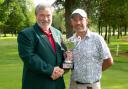 James Neve presented with his trophy by men's club captain Neil John.