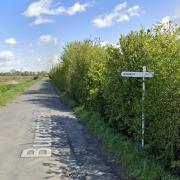 The plan would have seen up to seven new homes go up on the right side of Burrettgate Road, pictured here in May 2021 facing north. A sign can be seen pointing down Sandy Lane to Wisbech