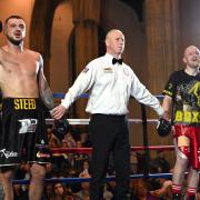 Joe Steed's arm is raised in victory by referee Mark Bates