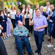 Mayor Dr Nik Johnson (front, third from left) with members of the Combined Authority team raise a mug for Macmillan's coffee morning event.