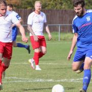 Jack Brand chases the ball for FC Parson Drove during their FA Vase first round qualifying tie with Godmanchester Rovers.