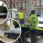 Vehicles parked at Wisbech war memorial were towed away before the town's Armistice Day service.