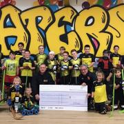 Skaters Roller Hockey Club team with the sponsorship cheque.