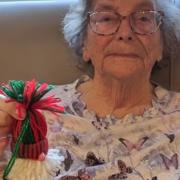 A resident holds up a hand made Christmas decoration which are on sale at Lyncroft Care Home, in Wisbech.