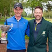 Club captain Andy Hicks presents overall winner Neil Cousins with his trophy