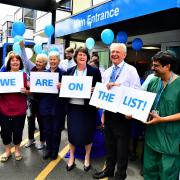 Staff at the Queen Elizabeth Hospital celebrate the news it will be replaced