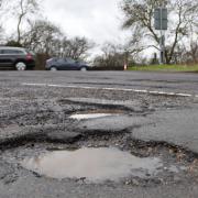 Stock image of a pothole.