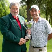 James Neve presented with his trophy by men's club captain Neil John.