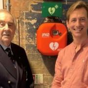 Richard Spendlove and Dan Schumann DL, founder of Viva Arts and Community Group, with the defibrillator,