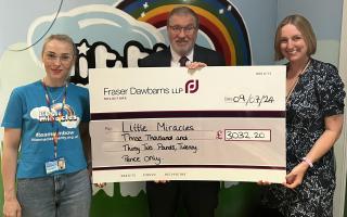 Krista Dolmane, finance manager at Little Miracles, and Neil John, partner and personal injury solicitor at Fraser Dawbarns LLP, presenting a cheque for fundraising to Louise Evans, head of income generation at Little Miracles at The Spinney.